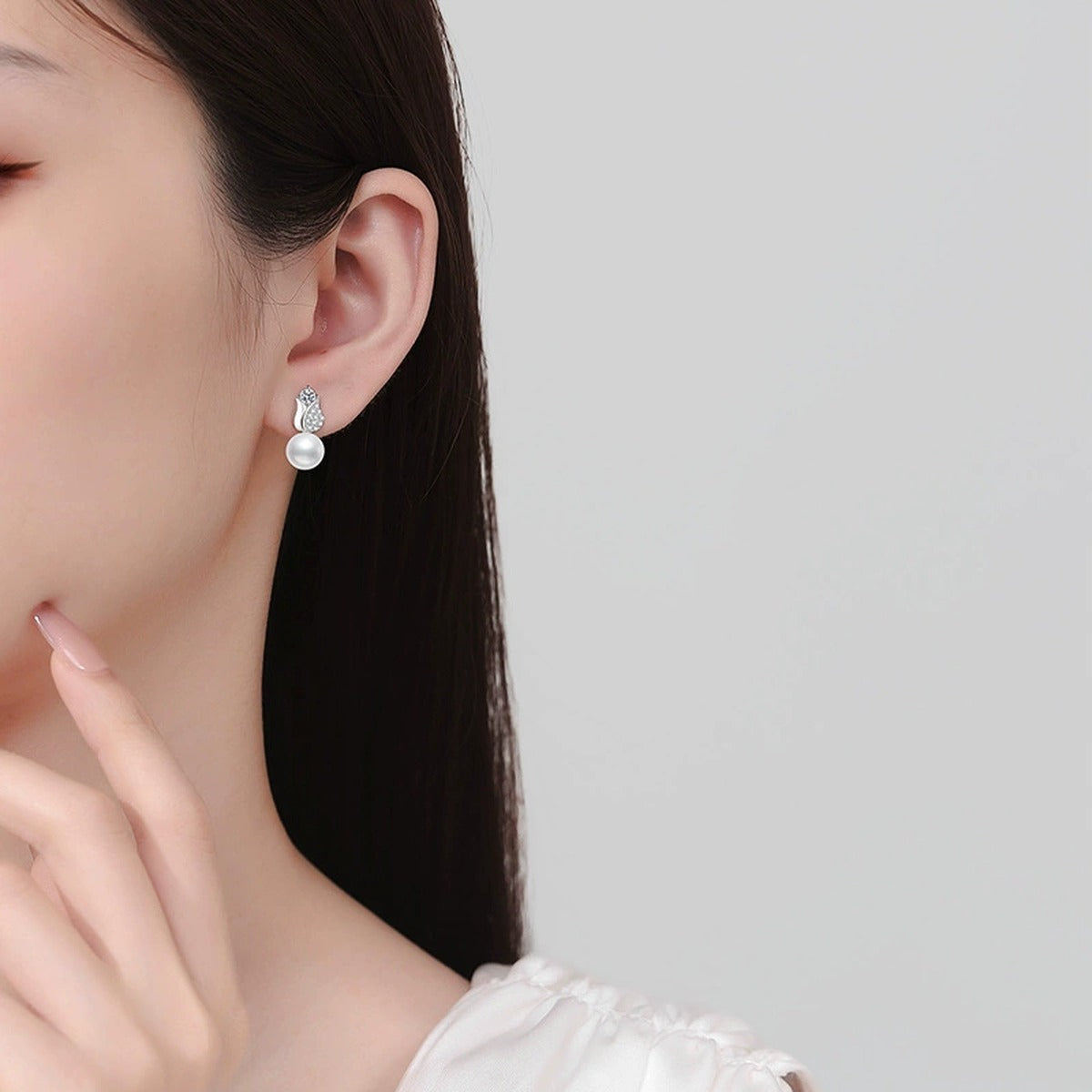 Leaf Pearl Moissanite Stud Drop Earrings with CZ in White Gold-Plated S925 Sterling Silver worn on ear by model