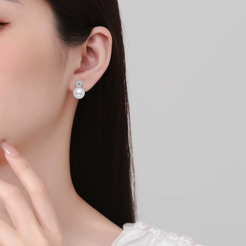 Halo Pearl Moissanite Stud Earrings with CZ in White Gold-Plated S925 Sterling Silver worn on ear by model