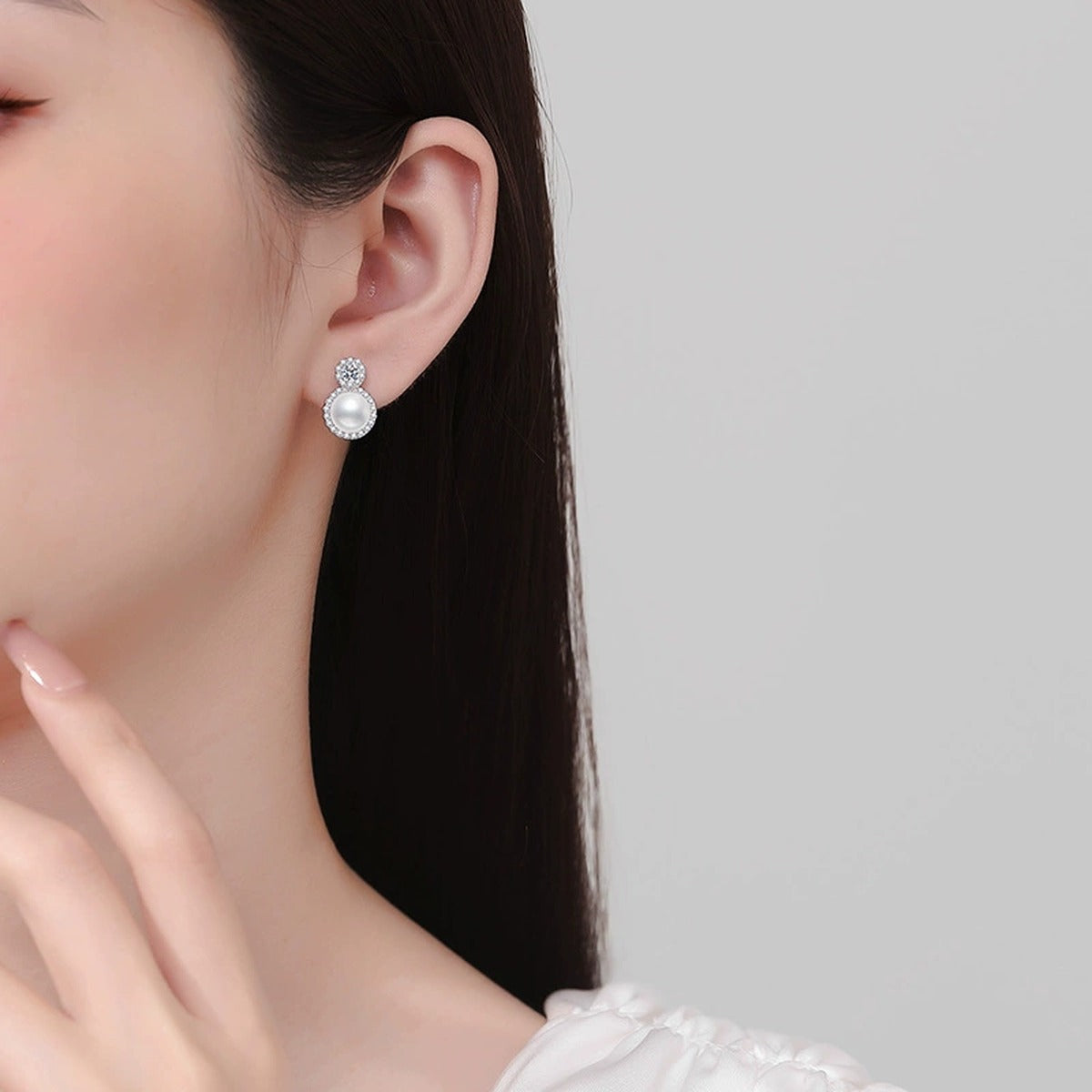 Halo Pearl Moissanite Stud Earrings with CZ in White Gold-Plated S925 Sterling Silver worn on ear by model