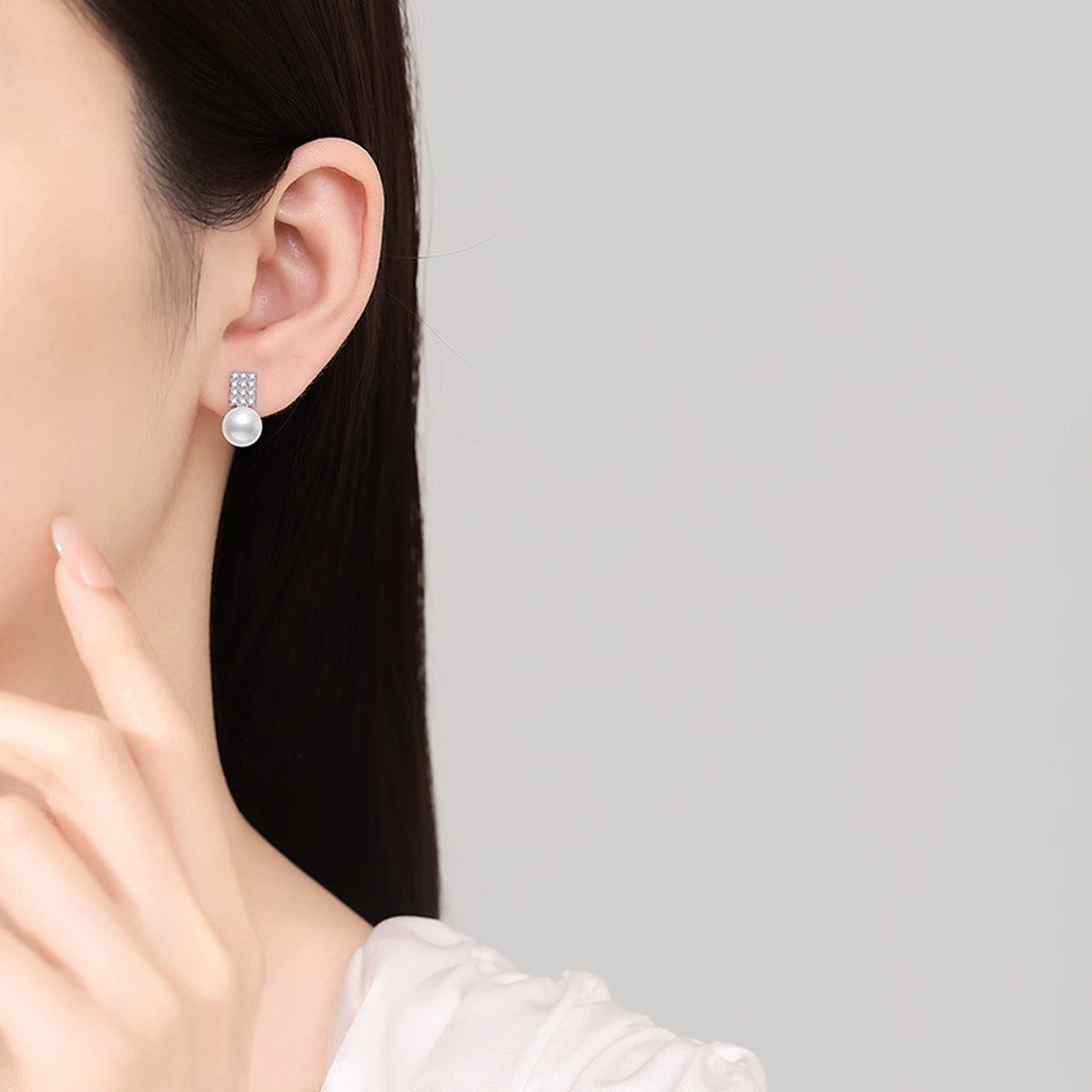 Rectangular Pearl Moissanite Stud Earrings in White Gold-Plated S925 Sterling Silver worn on ear by model