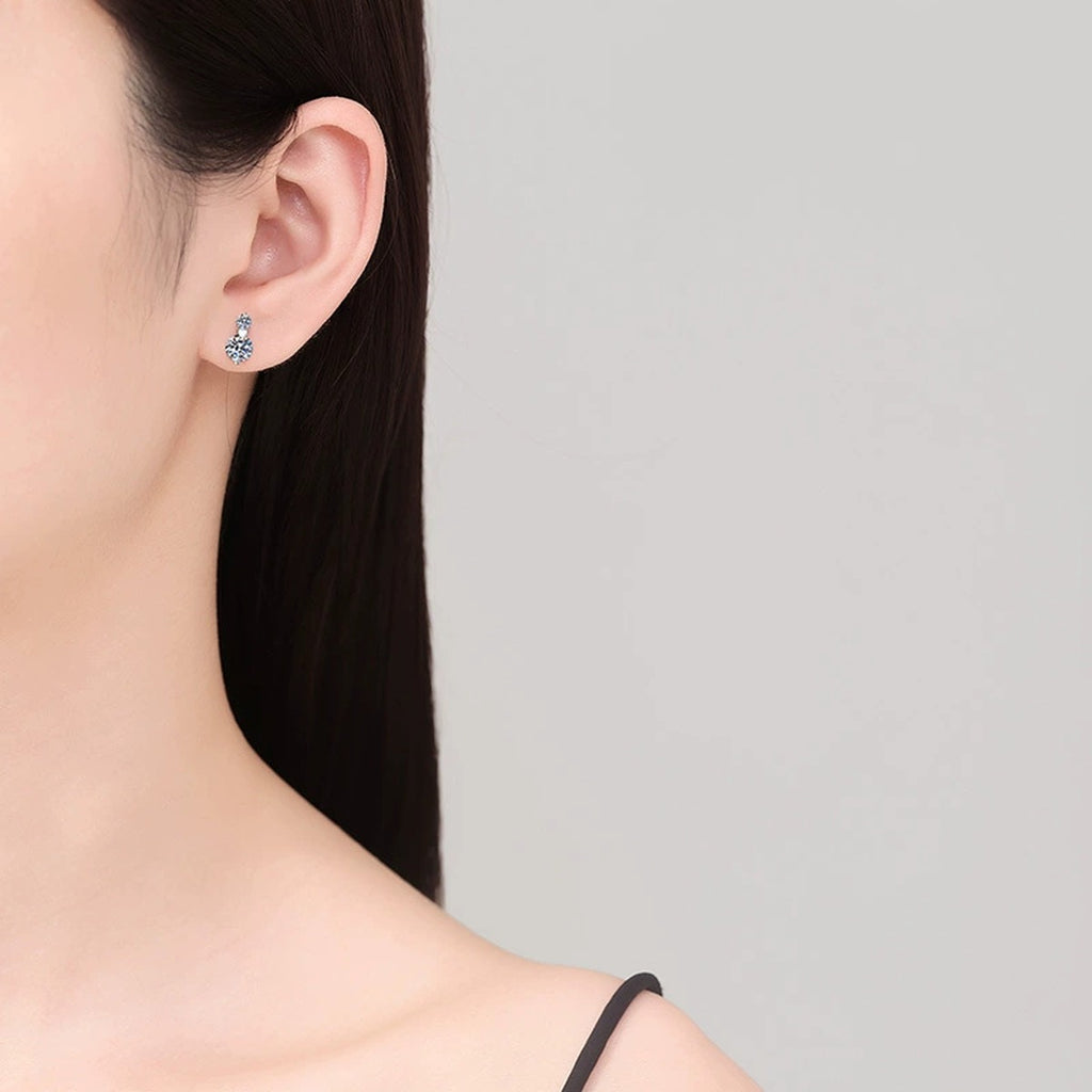 Pear Moissanite Stud Earrings with CZ in White Gold-Plated S925 Silver worn on ear by model