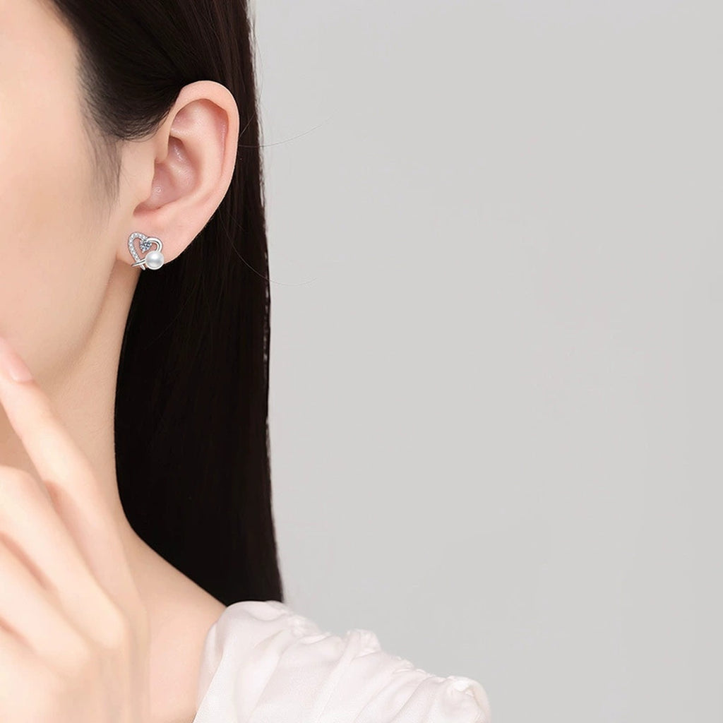 Heart Pearl Moissanite Stud Earrings with CZ in White Gold-Plated S925 Sterling Silver worn on ear by model