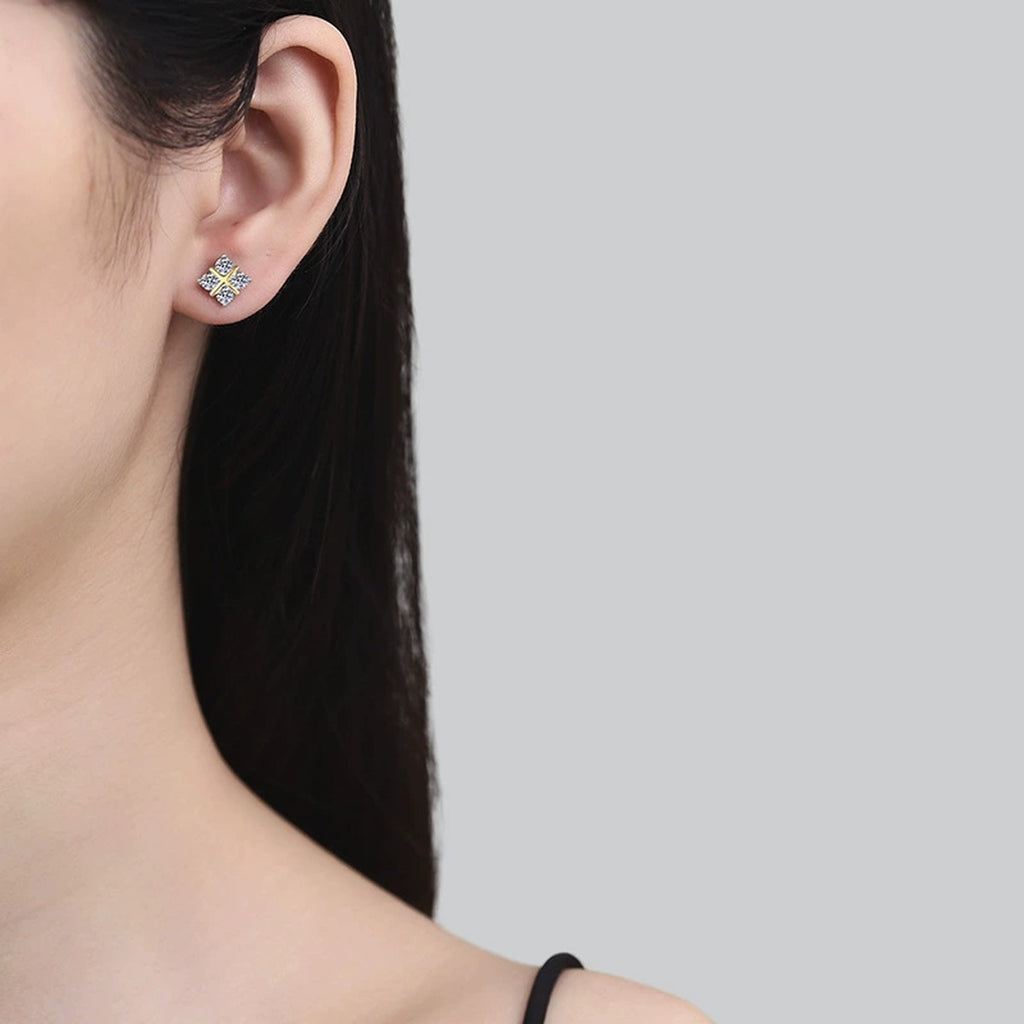 Two-Tone Moissanite X Stud Earrings in Gold-Plated S925 Sterling Silver worn on ear by model