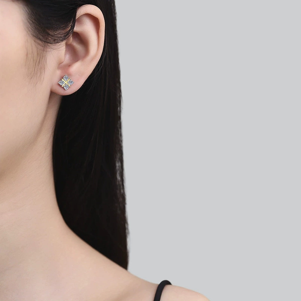 Two-Tone Moissanite X Stud Earrings in Gold-Plated S925 Sterling Silver worn on ear by model