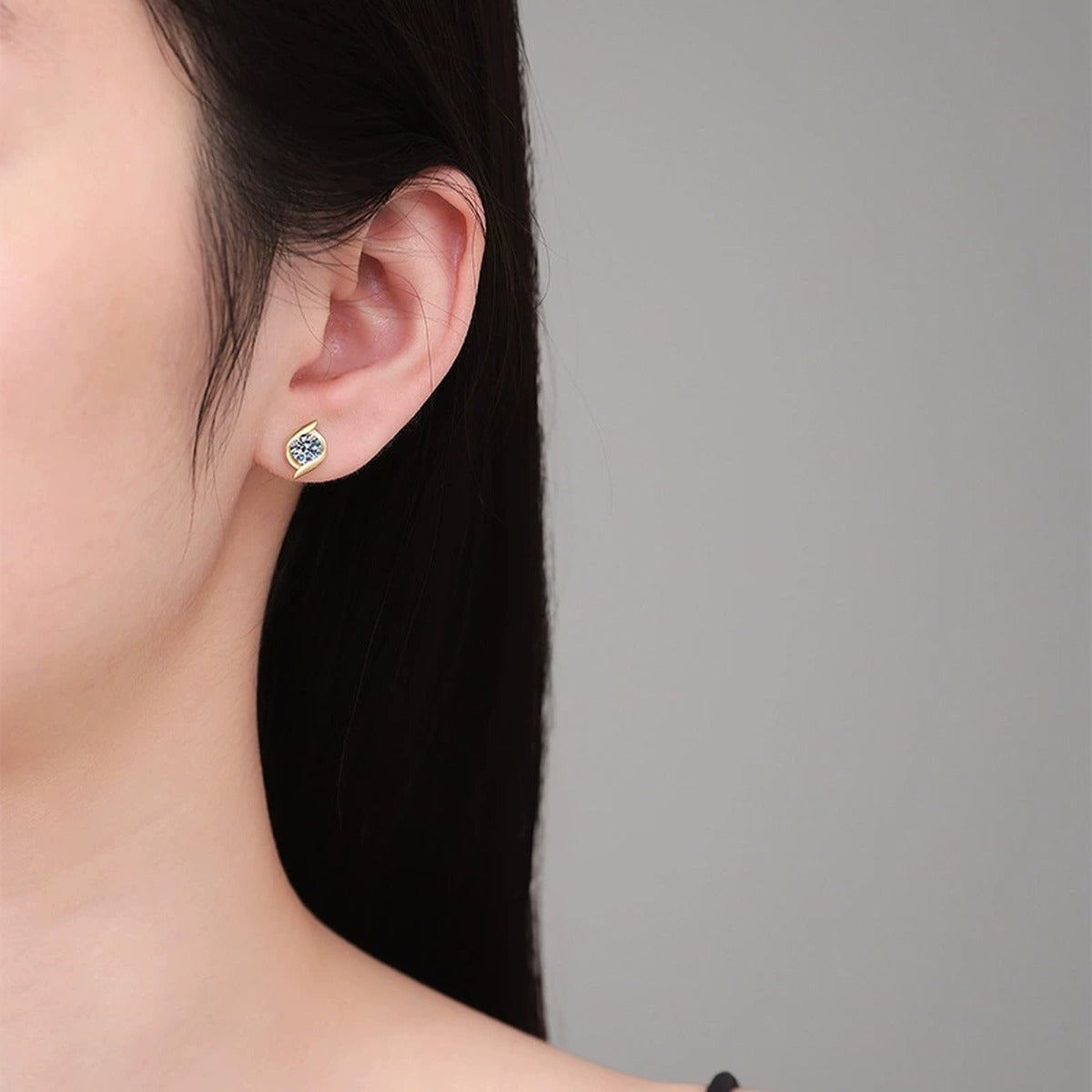 Pear Moissanite Stud Earrings in Gold-Plated S925 Sterling Silver worn on ear by model
