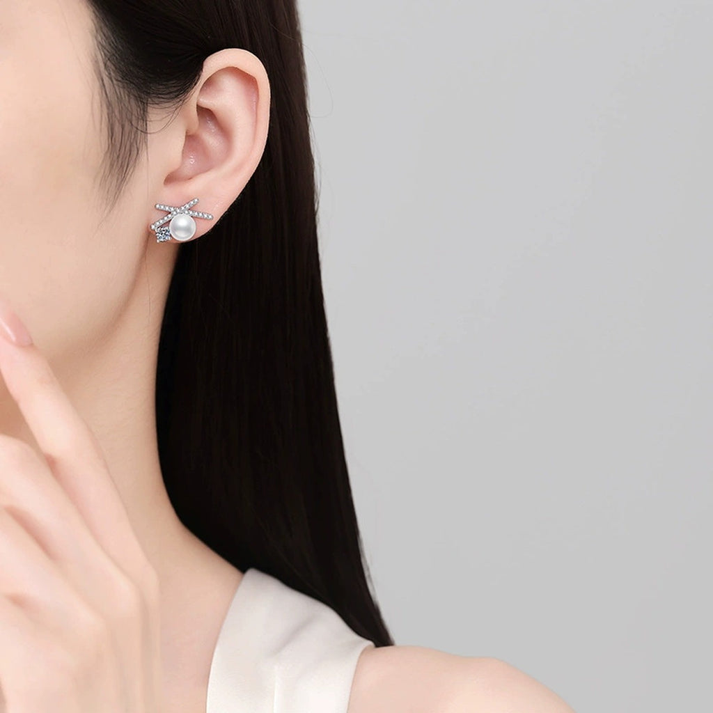 Bow Pearl Moissanite Stud Earrings with CZ in White Gold-Plated S925 Sterling Silver worn on ear by model