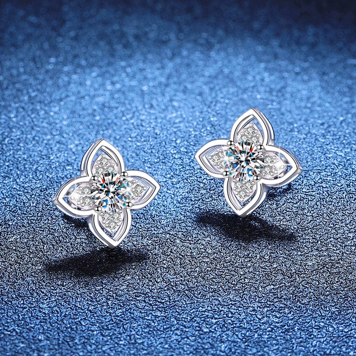 Four-Petal Moissanite Stud Earrings with CZ in White Gold-Plated S925 Sterling Silver blue scene angled view