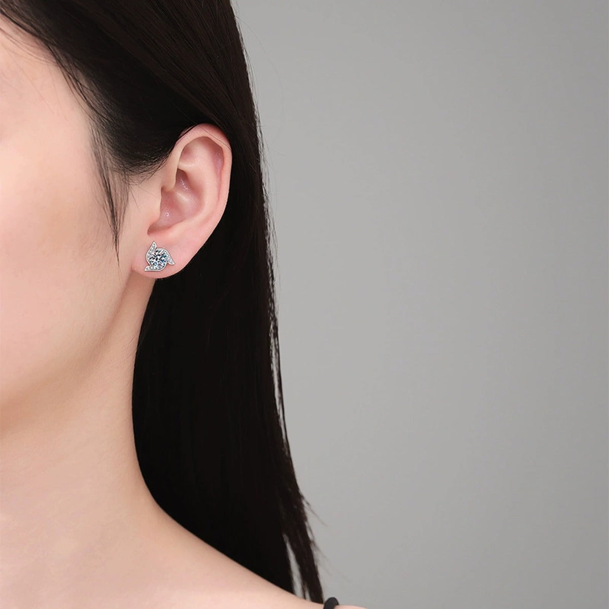 Model wearing platinum-plated S925 sterling silver leaf moissanite stud earrings