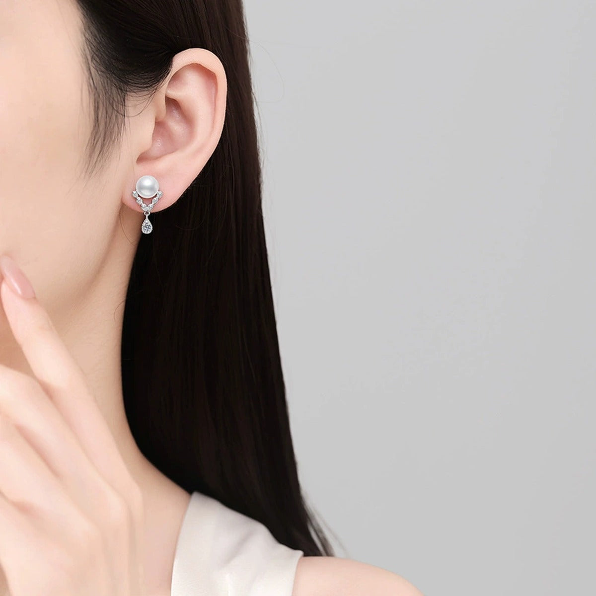 Pearl Moissanite Stud Drop Earrings with CZ in White Gold-Plated S925 Sterling Silver worn on ear by model