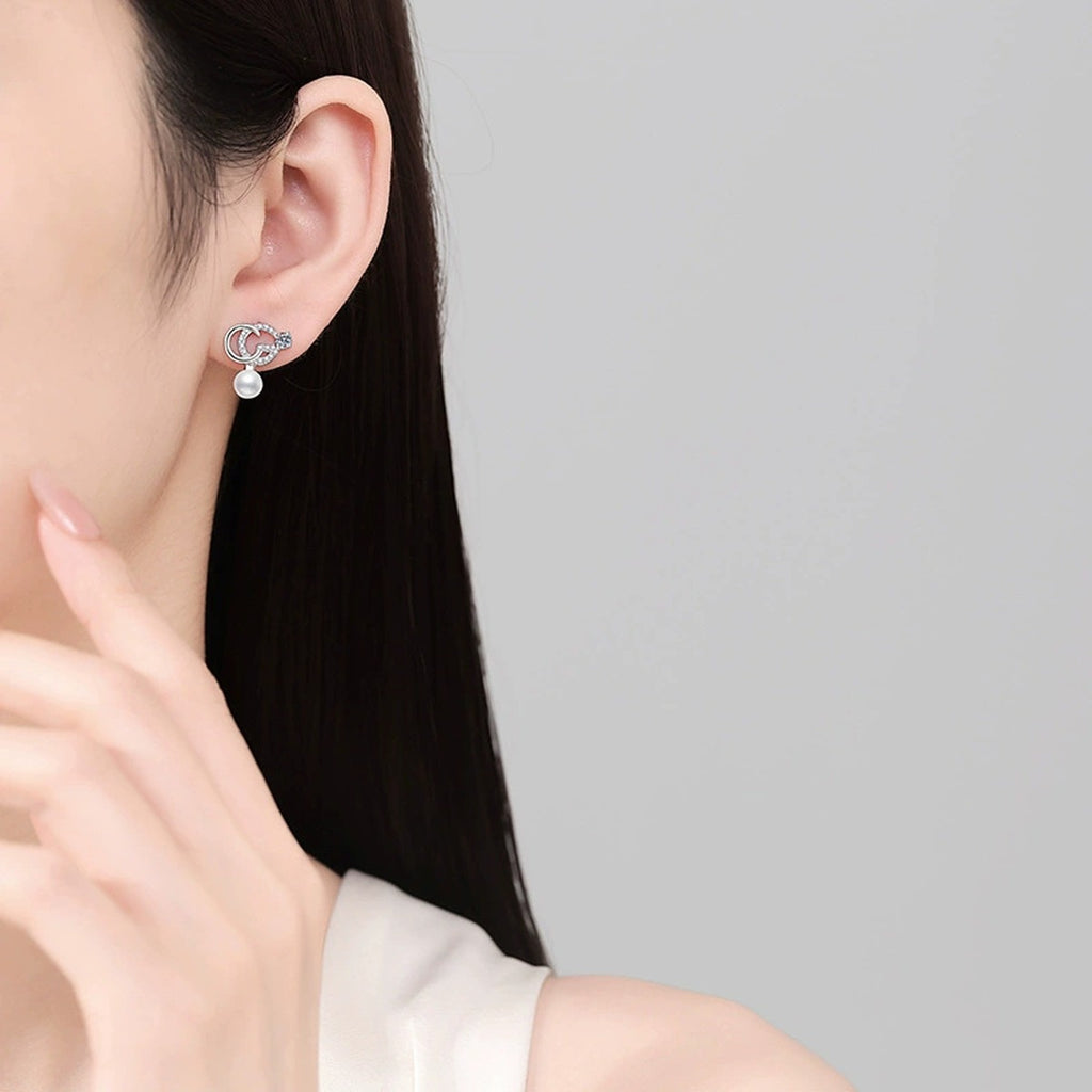 Crescent Pearl Moissanite Stud Drop Earrings with CZ in White Gold-Plated S925 Sterling Silver worn on ear by model