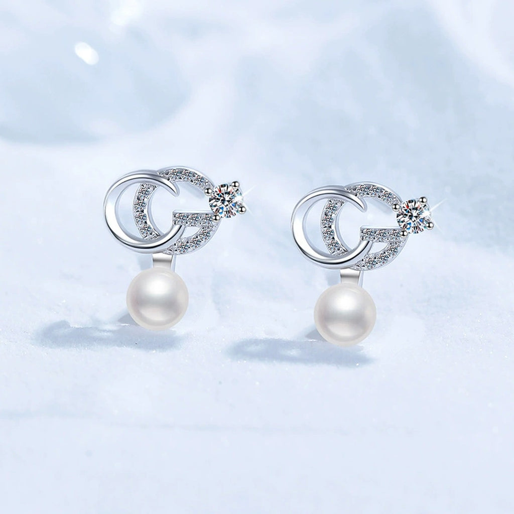 Crescent Pearl Moissanite Stud Drop Earrings with CZ in White Gold-Plated S925 Sterling Silver blue scene angled view