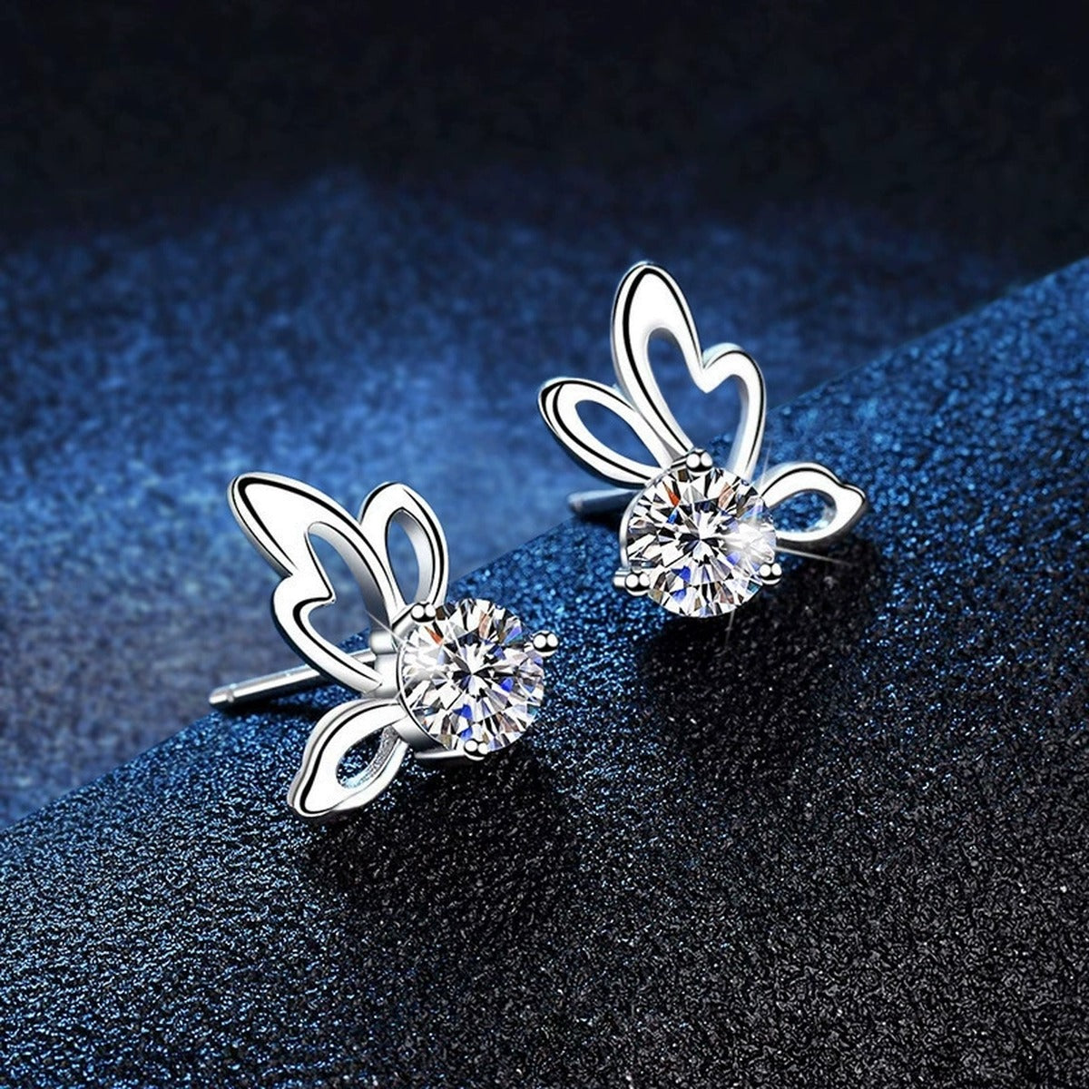 Butterfly Moissanite Stud Earrings in White Gold-Plated S925 Sterling Silver blue scene angled view