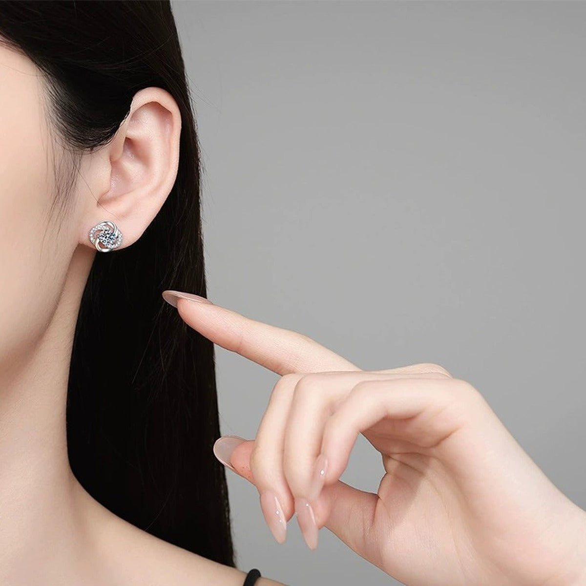 Swirl Moissanite Stud Earrings with CZ in White Gold-Plated S925 Sterling Silver worn on ear by model