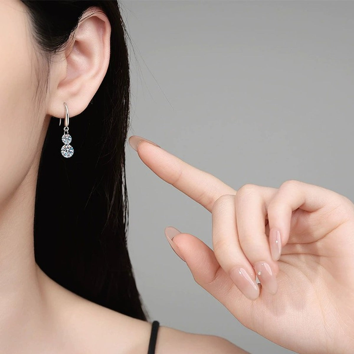 Two-Stone Moissanite Drop Earrings in White Gold-Plated S925 Sterling Silver worn on ear by model