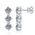 Three-Stone Moissanite Stud Earrings in White Gold-Plated S925 Sterling Silver on clean white background showing a vertical three-stone stud with round moissanite stones