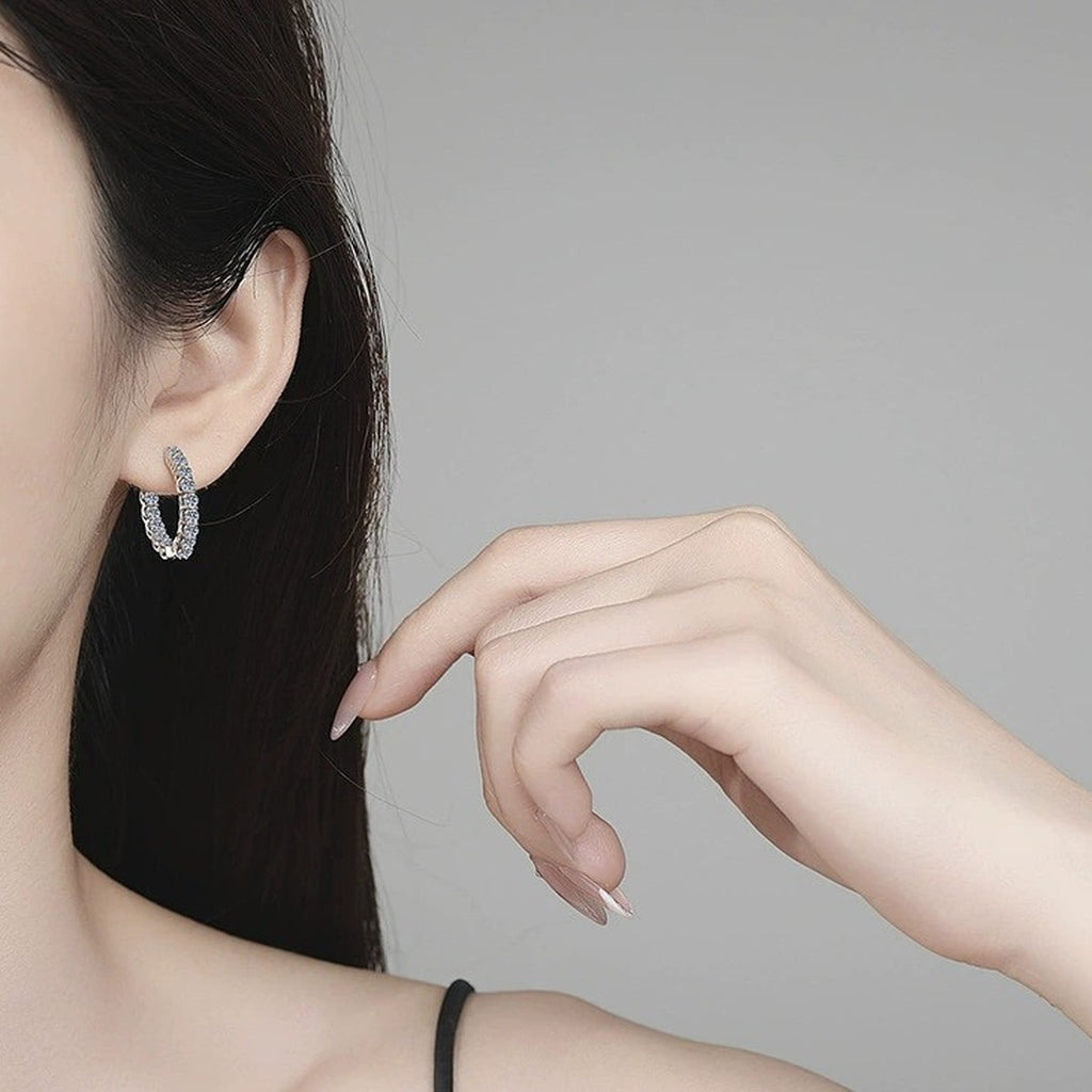 Oval Pave Moissanite Hoop Earrings in White Gold-Plated S925 Sterling Silver worn on ear by model