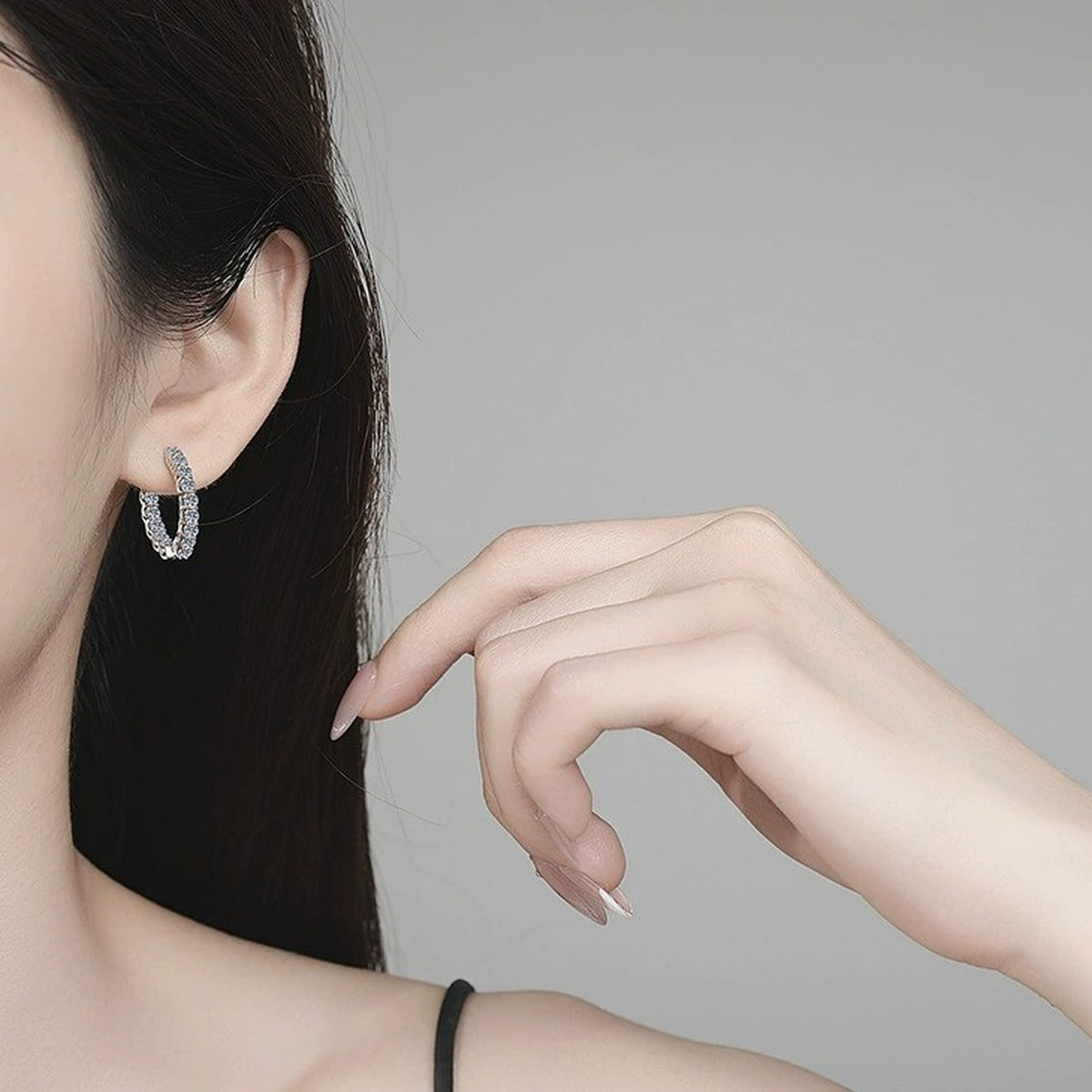 Oval Pave Moissanite Hoop Earrings in White Gold-Plated S925 Sterling Silver worn on ear by model