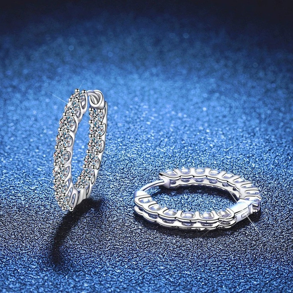 Oval Pave Moissanite Hoop Earrings in White Gold-Plated S925 Sterling Silver blue scene angled view