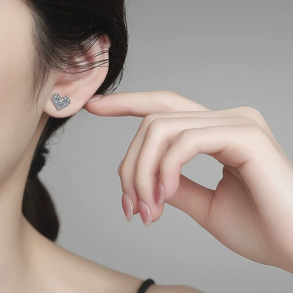 Heart Moissanite Stud Earrings in White Gold-Plated S925 Sterling Silver worn on ear by model