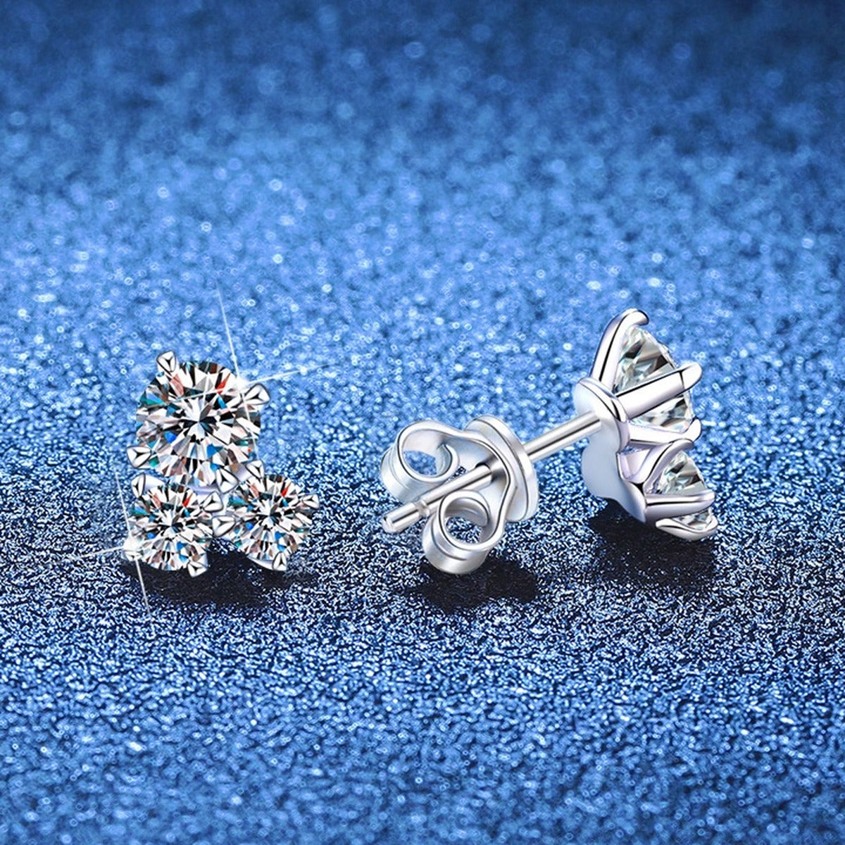 Three-Stone Moissanite Stud Earrings in White Gold-Plated S925 Sterling Silver blue scene angled view