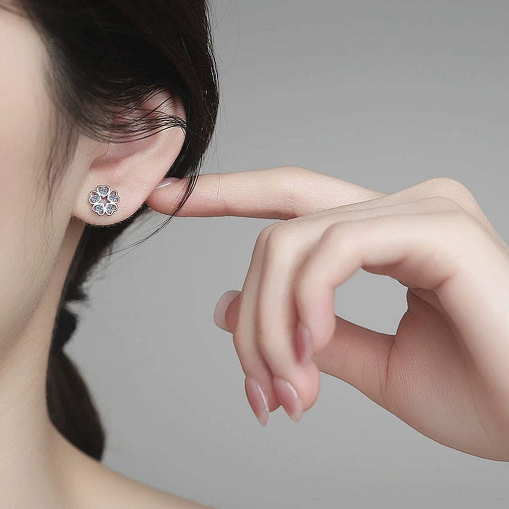 Five-Petal Moissanite Stud Earrings in White Gold-Plated S925 Sterling Silver worn on ear by model