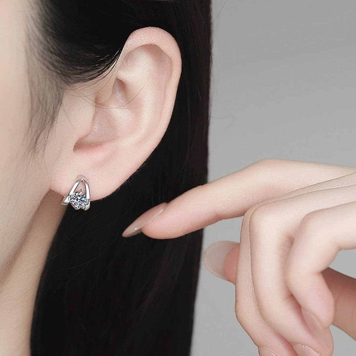 Round Moissanite Huggie Hoop Earrings in White Gold-Plated S925 Sterling Silver worn on ear by model