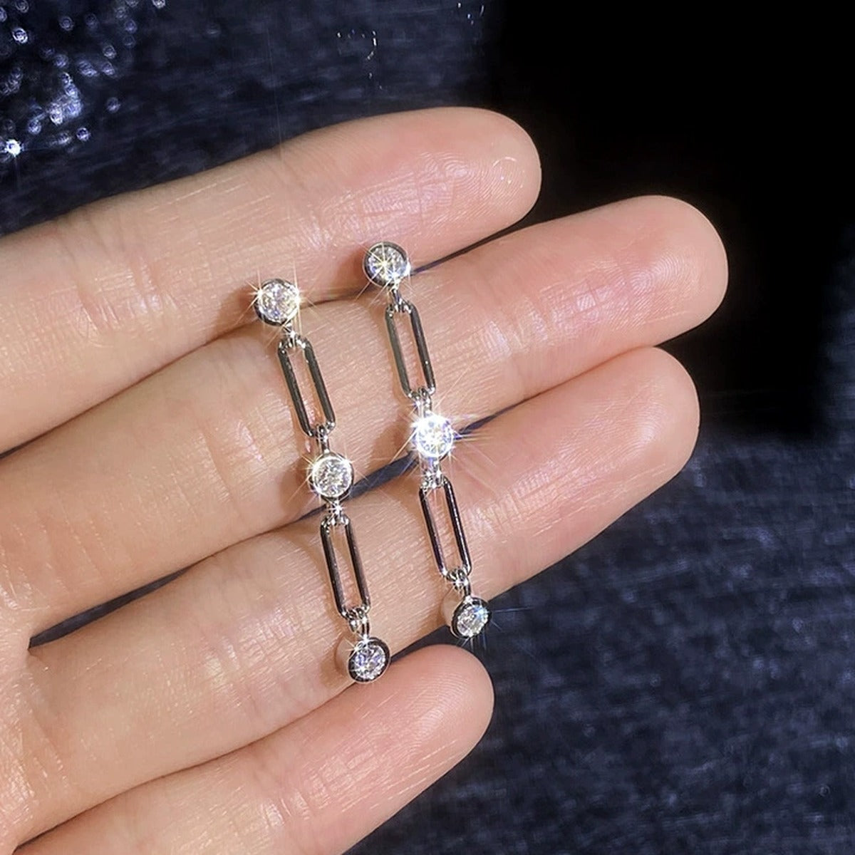 Link Chain Moissanite Drop Earrings in White Gold-Plated S925 Sterling Silver show on hand
