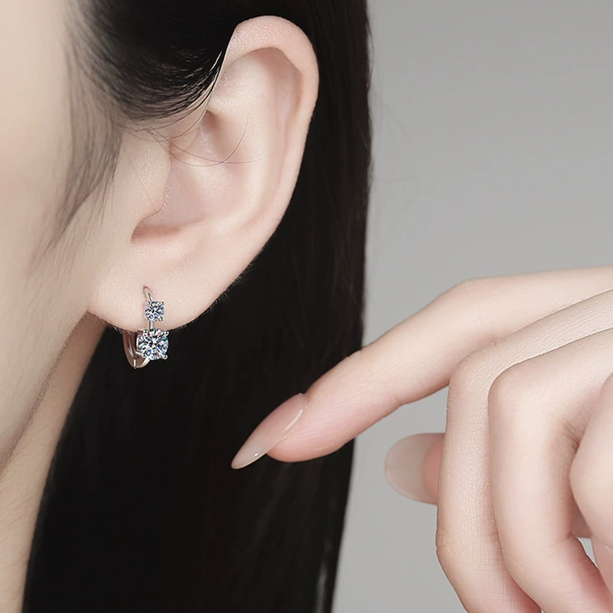 Two-Stone Moissanite Hoop Earrings in White Gold-Plated S925 Sterling Silver worn on ear by model