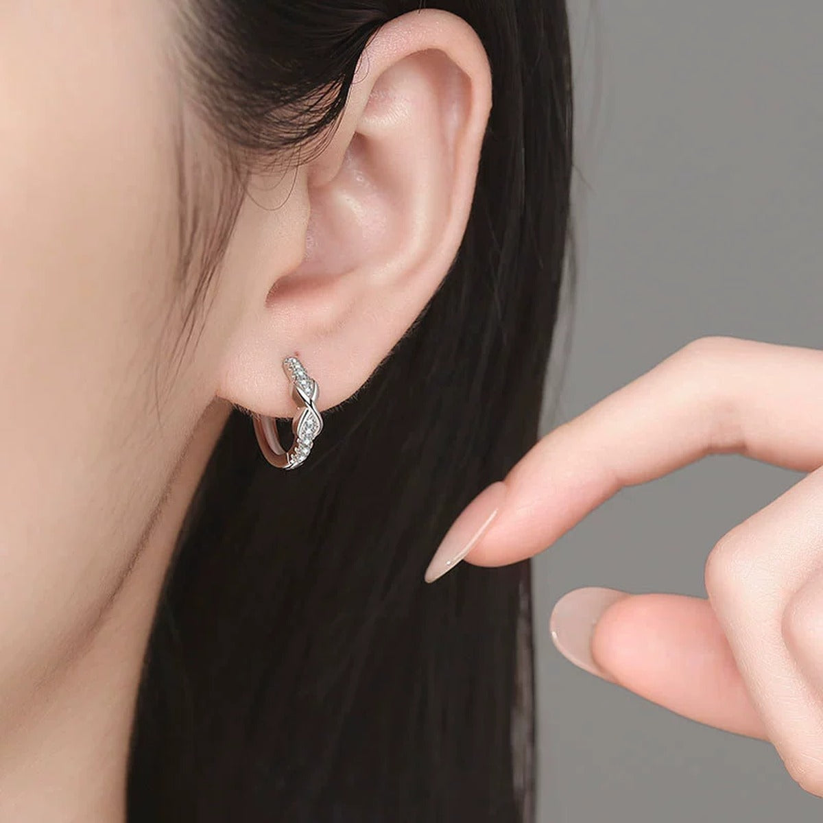 Twisted Pave Moissanite Hoop Earrings in White Gold-Plated S925 Sterling Silver worn on ear by model
