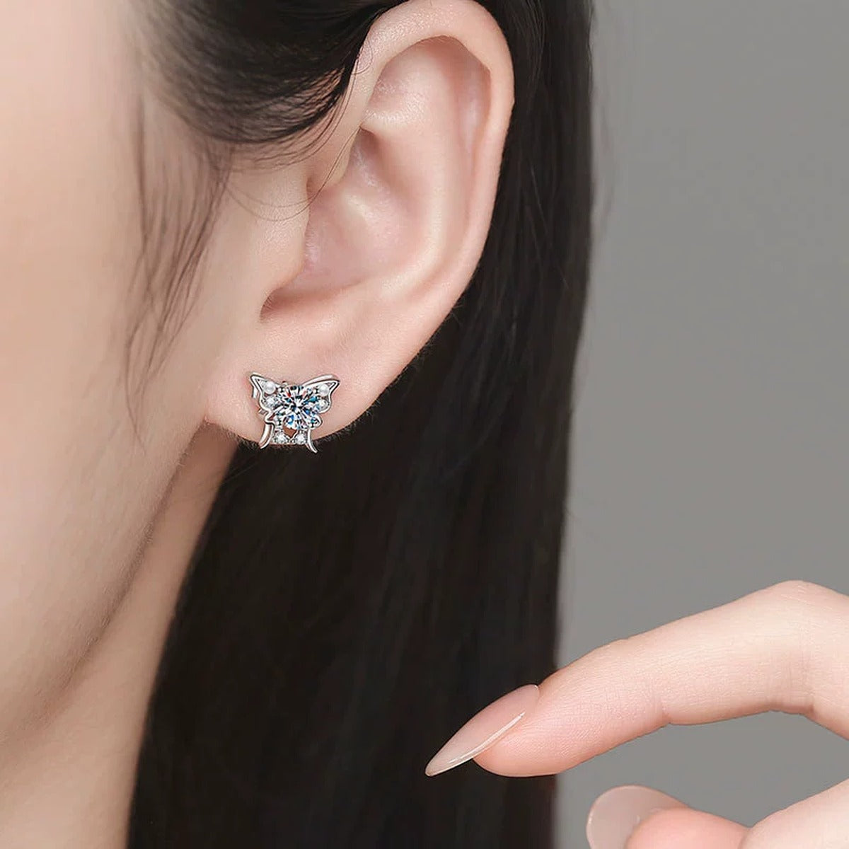 Bow Moissanite Stud Earrings with CZ in White Gold-Plated S925 Sterling Silver worn on ear by model