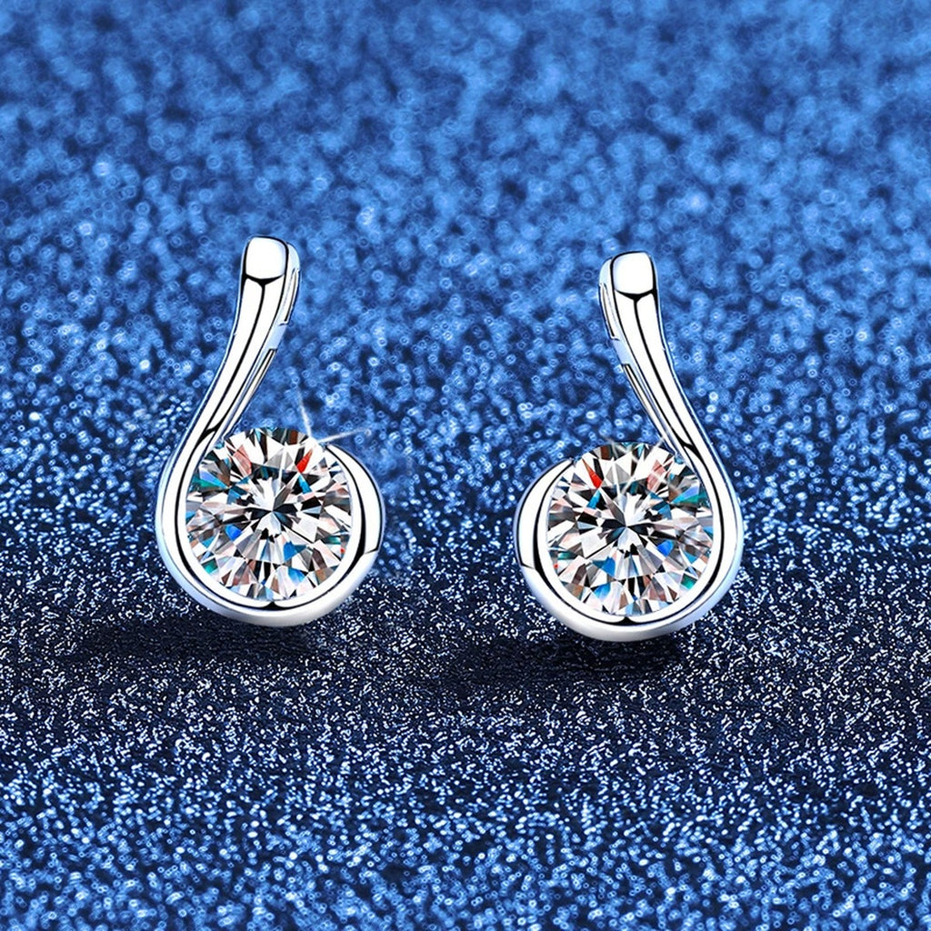 Curved Teardrop Moissanite Stud Earrings in White Gold-Plated S925 Sterling Silver blue scene angled view