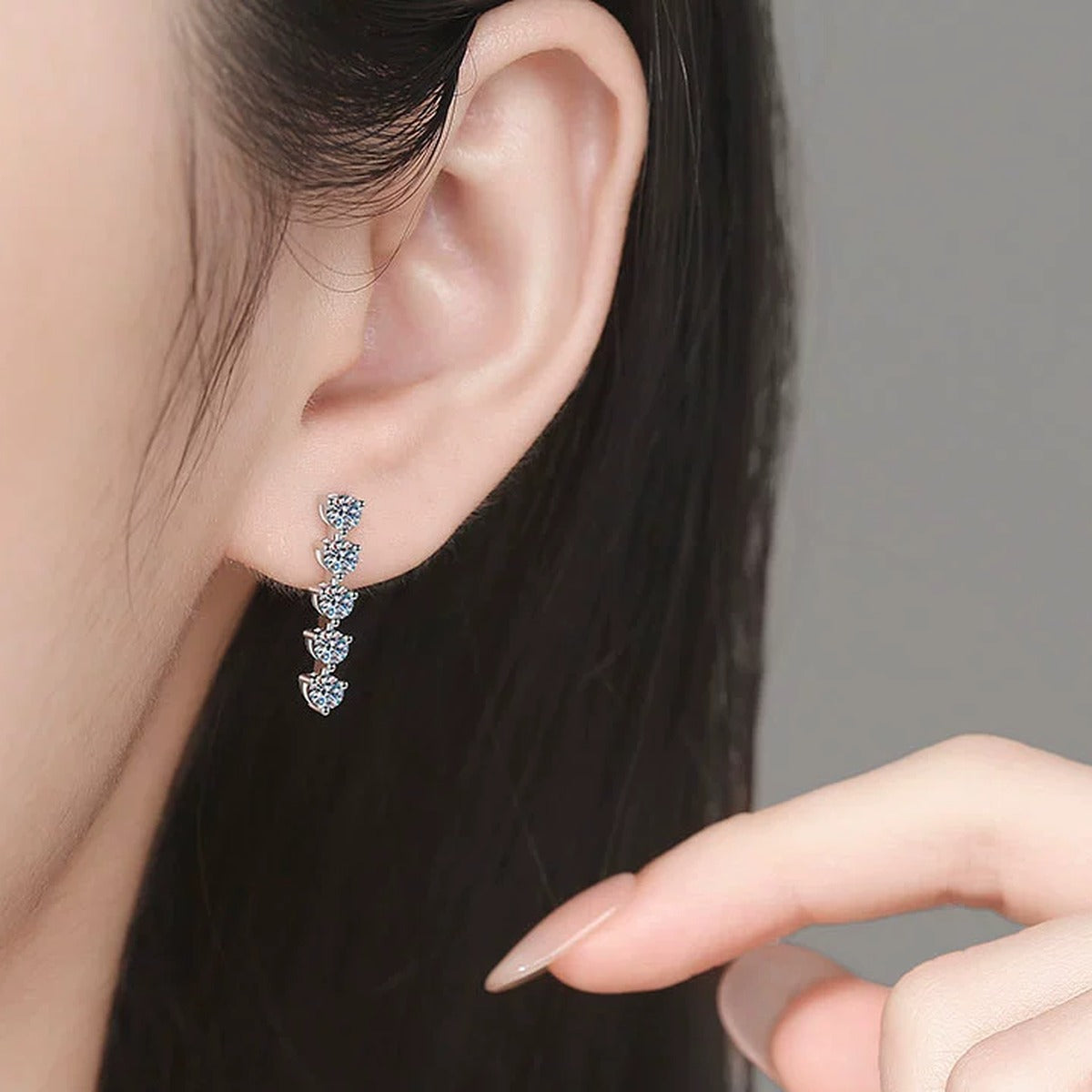 Five-Stone Moissanite Drop Earrings in White Gold-Plated S925 Sterling Silver worn on ear by model