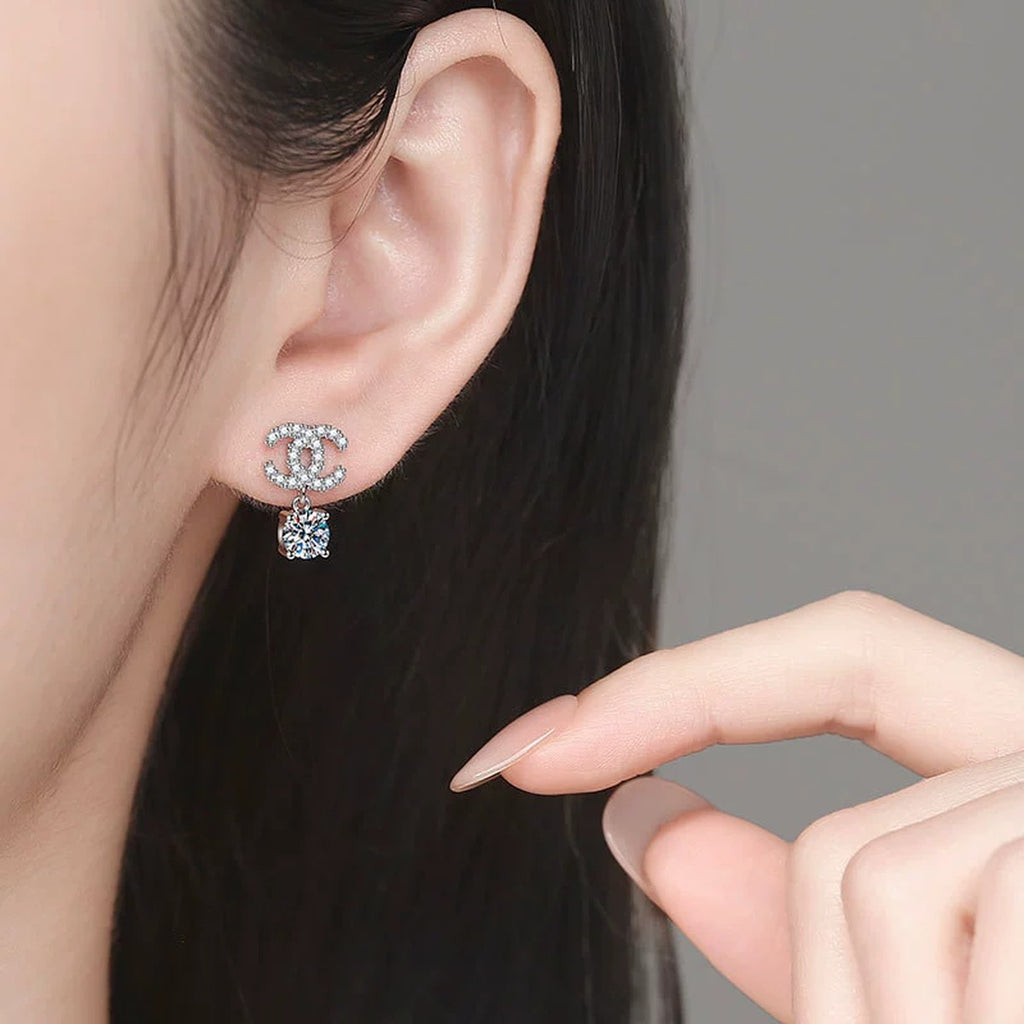 Ribbon Drop Moissanite Stud Earrings with CZ in White Gold-Plated S925 Sterling Silver worn on ear by model