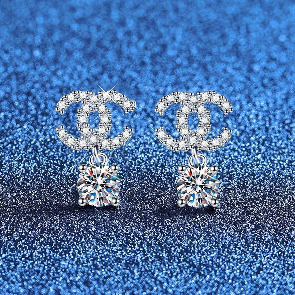 Ribbon Drop Moissanite Stud Earrings with CZ in White Gold-Plated S925 Sterling Silver blue scene angled view