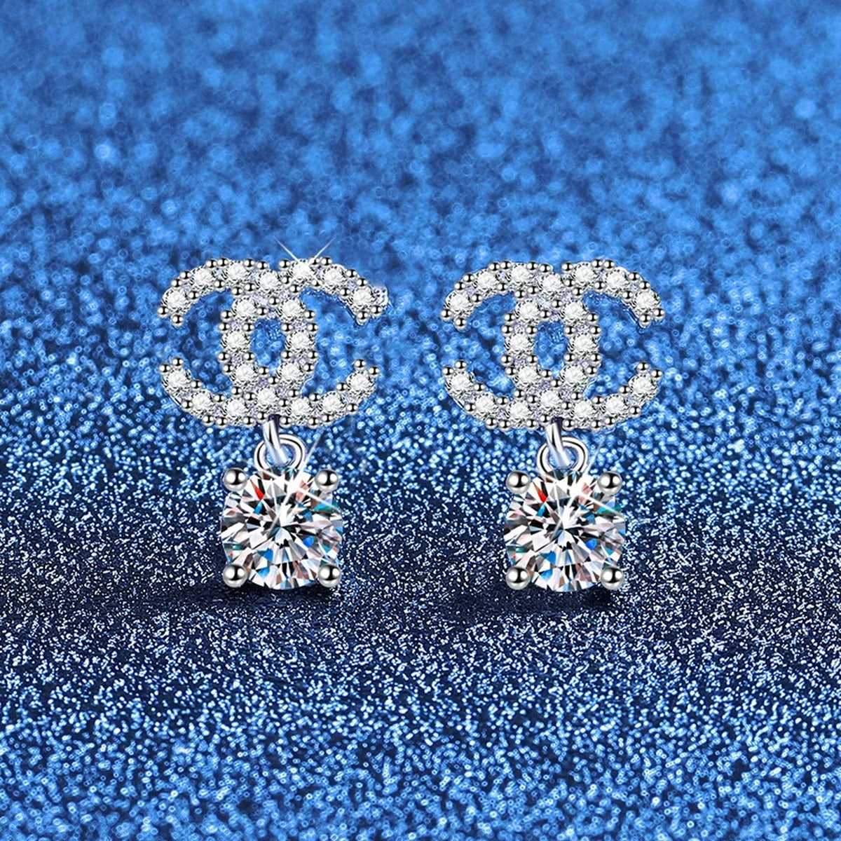 Ribbon Drop Moissanite Stud Earrings with CZ in White Gold-Plated S925 Sterling Silver blue scene angled view