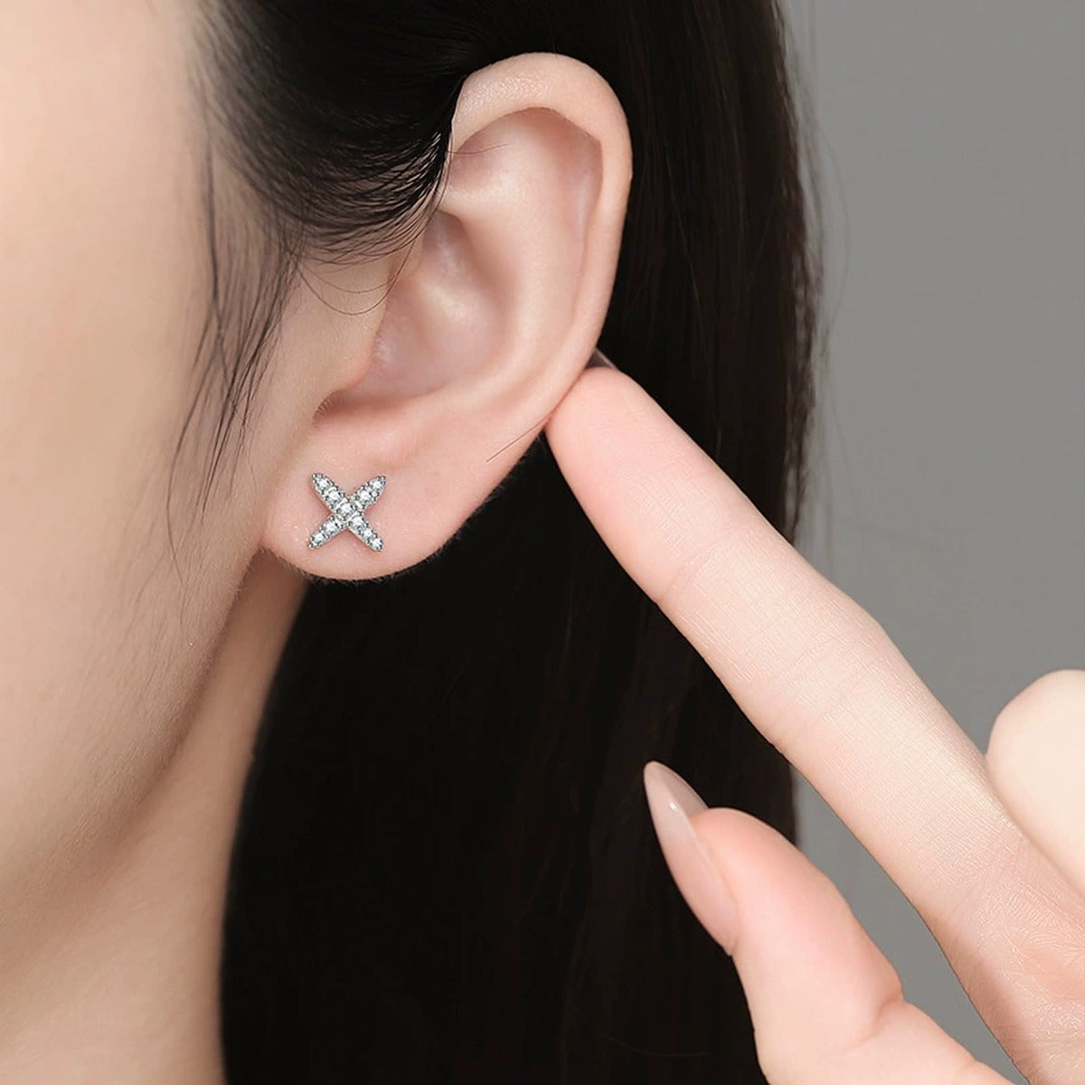 Cross Moissanite Stud Earrings in White Gold-Plated S925 Sterling Silver worn on ear by model