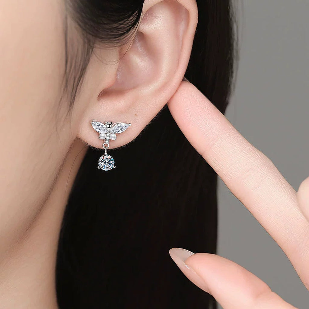 Bow Drop Moissanite Earrings with CZ in White Gold-Plated S925 Sterling Silver worn on ear by model
