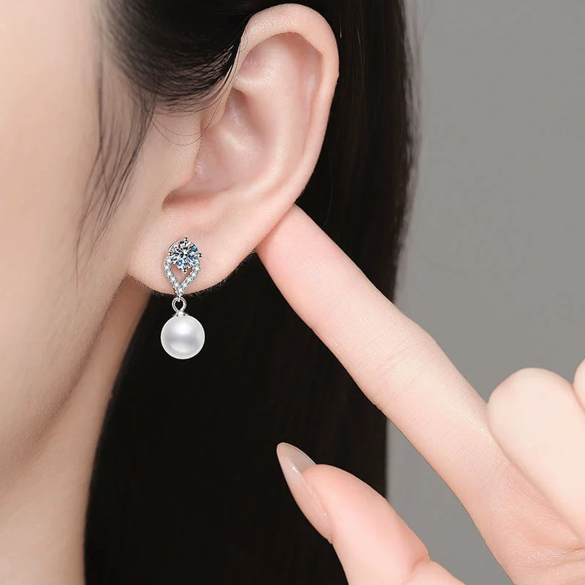 Pearl Teardrop Moissanite Earrings with CZ in White Gold-Plated S925 Sterling Silver worn on ear by model