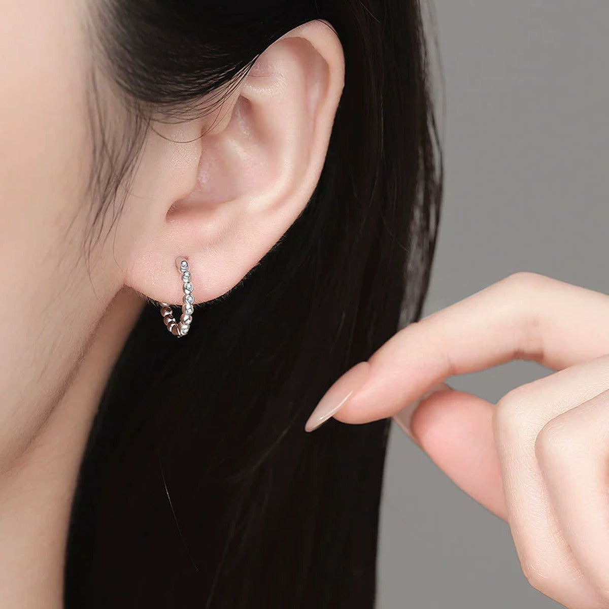 Beaded Moissanite Hoop Earrings in White Gold-Plated S925 Sterling Silver worn on ear by model