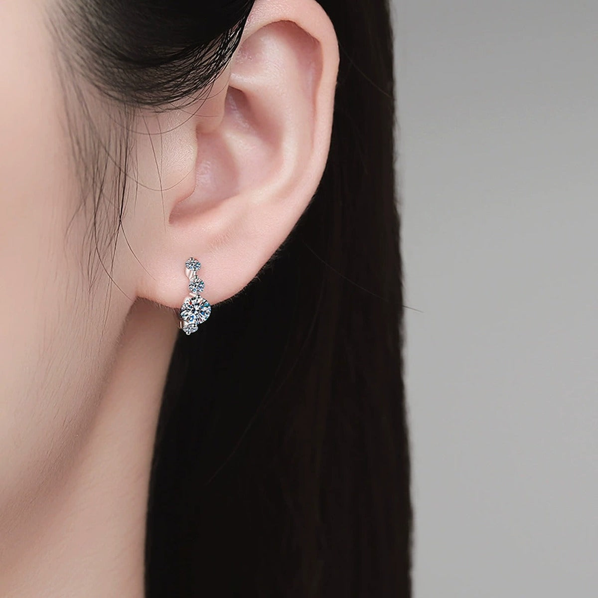 Graduated Moissanite Hoop Earrings in White Gold-Plated S925 Sterling Silver with CZ worn on ear by model