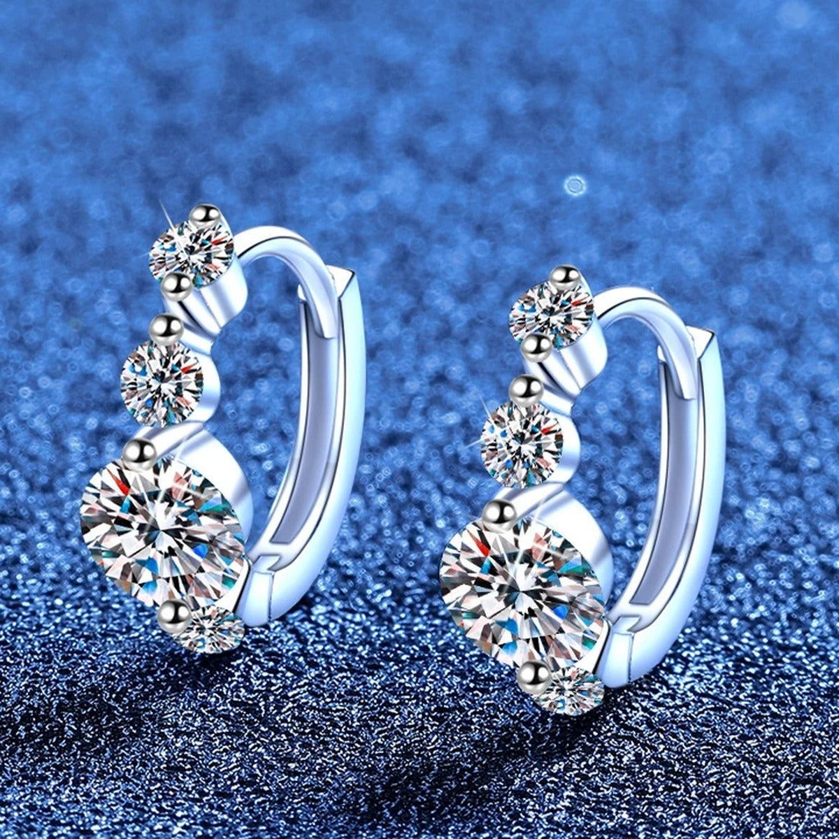 Graduated Moissanite Hoop Earrings in White Gold-Plated S925 Sterling Silver with CZ blue scene angled view