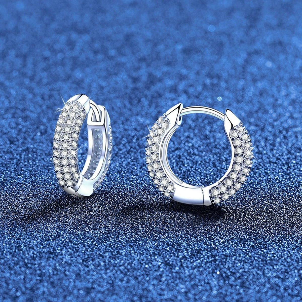 Pave Moissanite Huggie Hoop Earrings in White Gold-Plated S925 Sterling Silver blue scene angled view