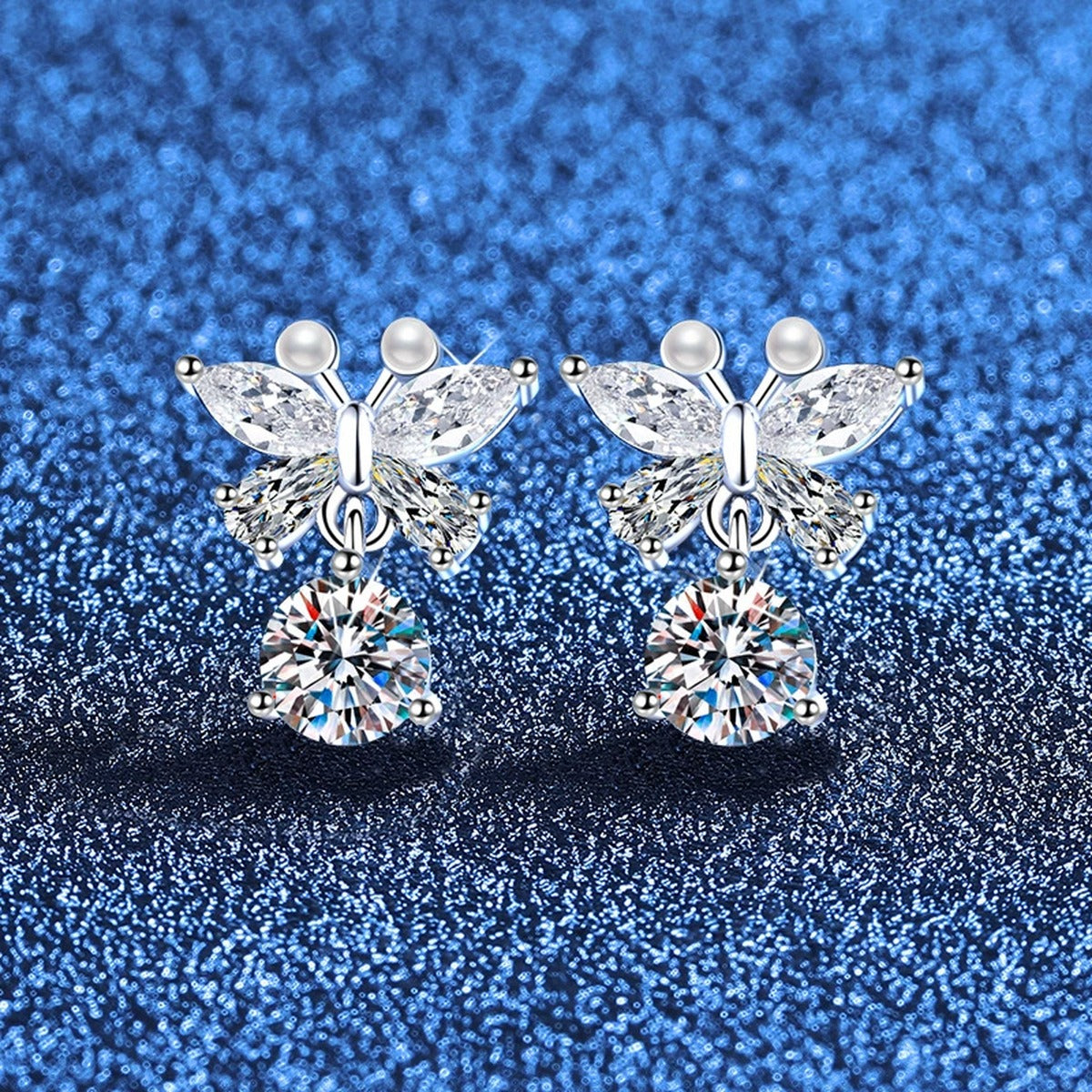 Butterfly Moissanite Stud Drop Earrings with CZ in White Gold-Plated S925 Sterling Silver blue background pair product view