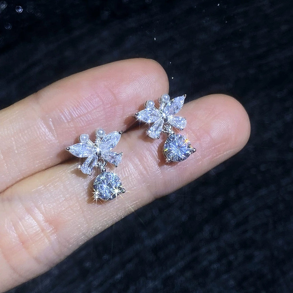Butterfly Moissanite Stud Drop Earrings with CZ in White Gold-Plated S925 Sterling Silver close-up product detail view held on hand