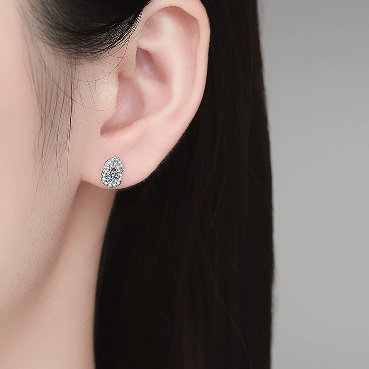 Pear Moissanite Stud Earrings with CZ in White Gold-Plated S925 Sterling Silver worn on ear by model