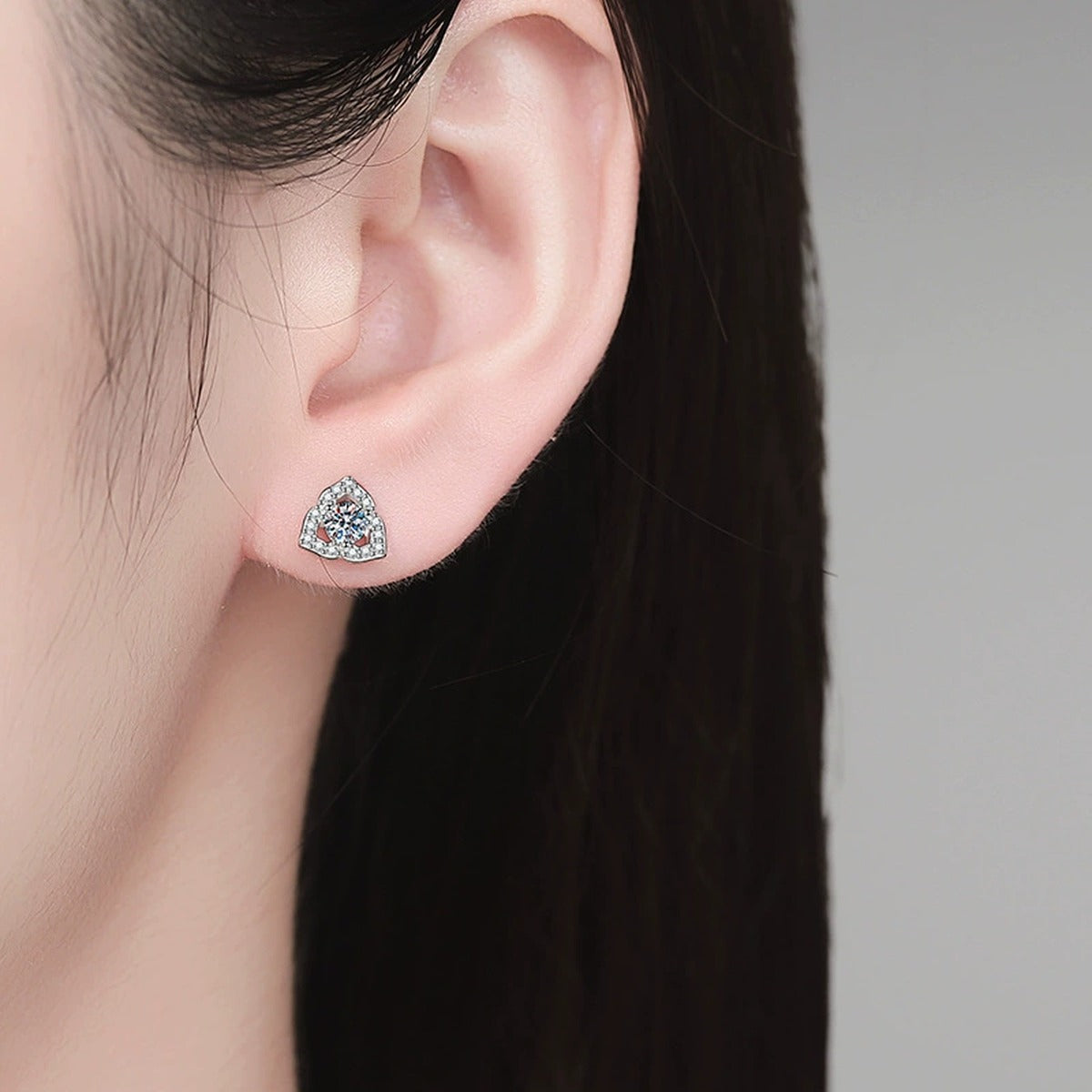 Pear Halo Moissanite Stud Earrings with CZ in White Gold-Plated S925 Sterling Silver worn on ear by model