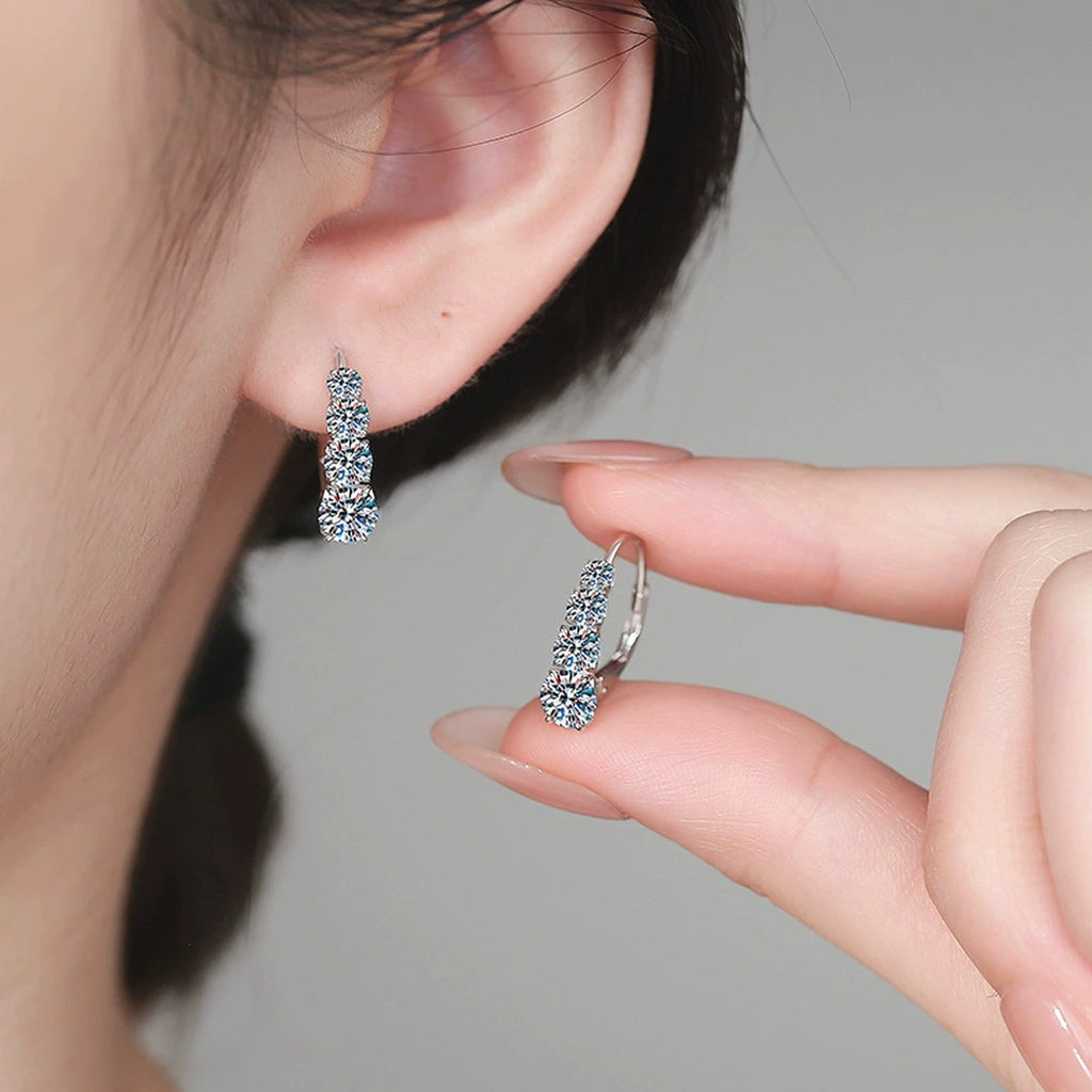 Graduated Moissanite Hoop Earrings in White Gold-Plated S925 Sterling Silver worn on ear by model
