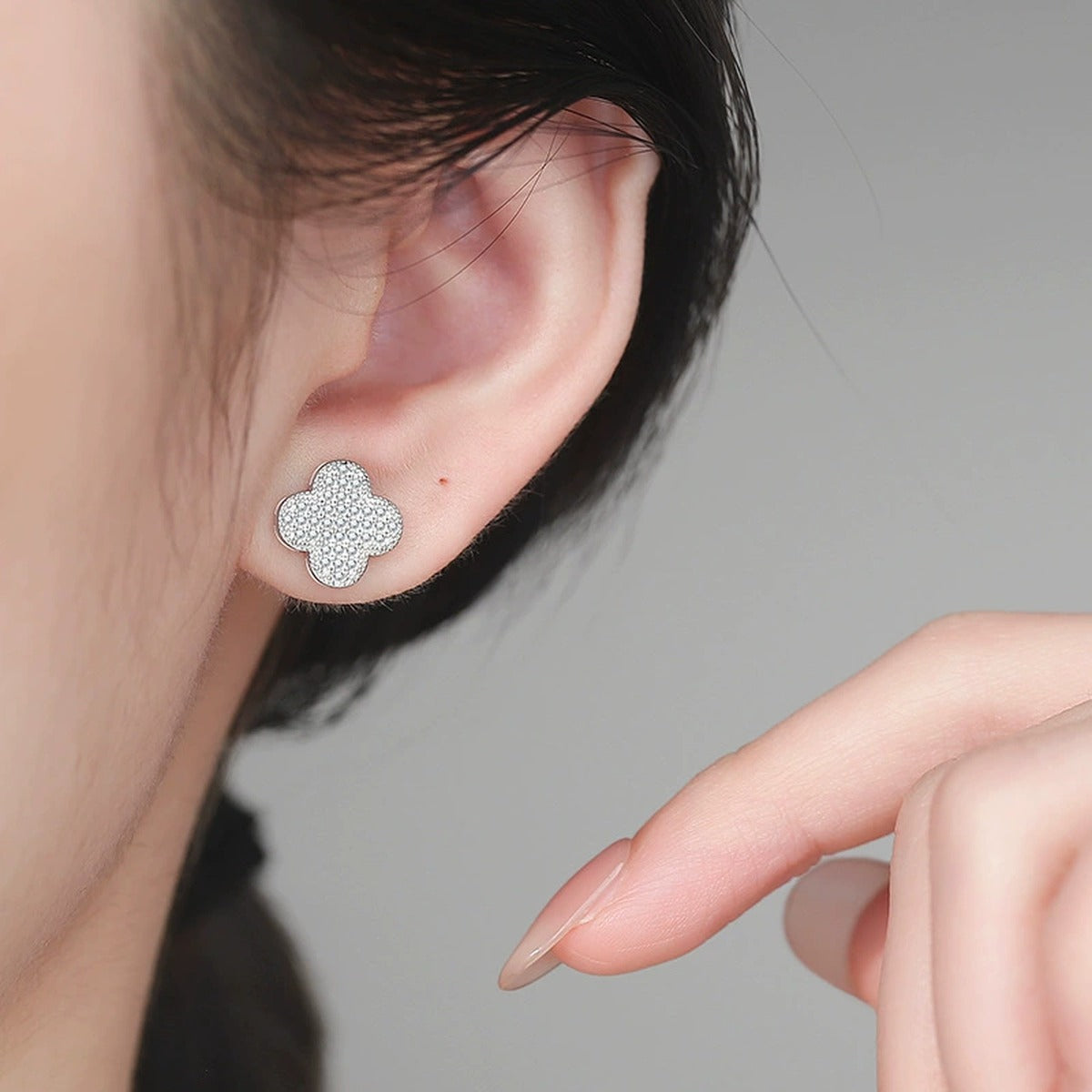Clover Pave Moissanite Stud Earrings in White Gold-Plated S925 Sterling Silver worn on ear by model