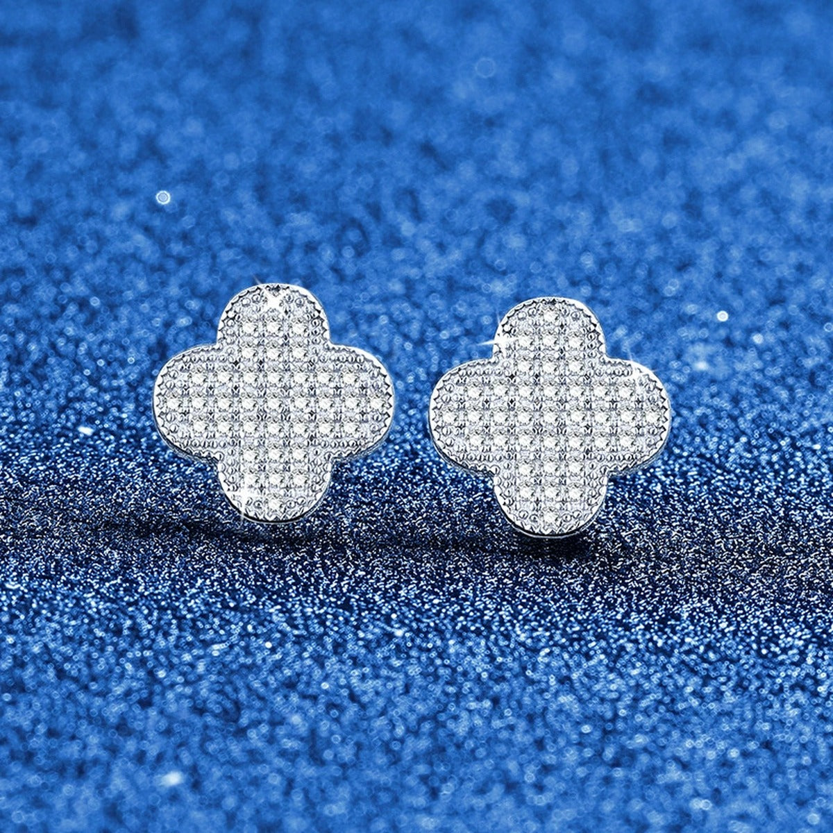 Clover Pave Moissanite Stud Earrings in White Gold-Plated S925 Sterling Silver blue scene angled view