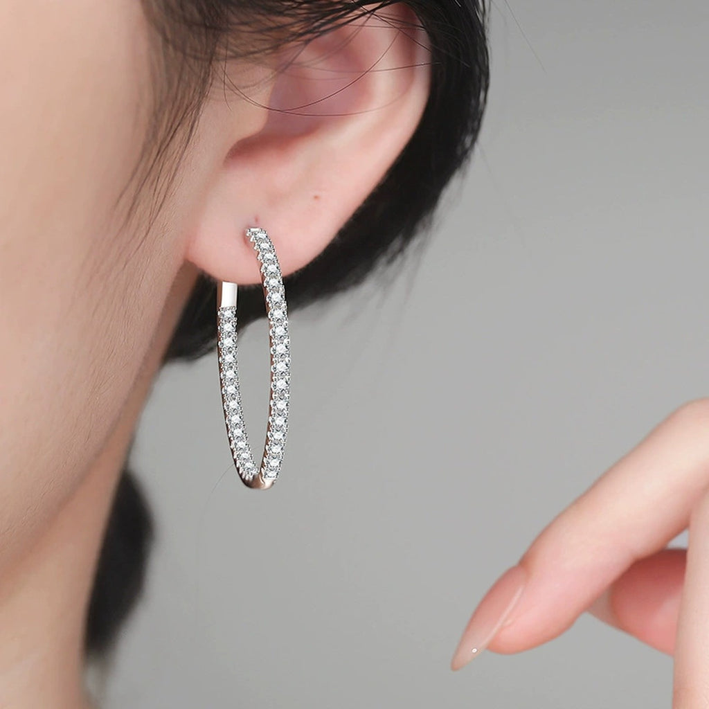 Large Pave Moissanite Hoop Earrings in White Gold-Plated S925 Sterling Silver worn on ear by model
